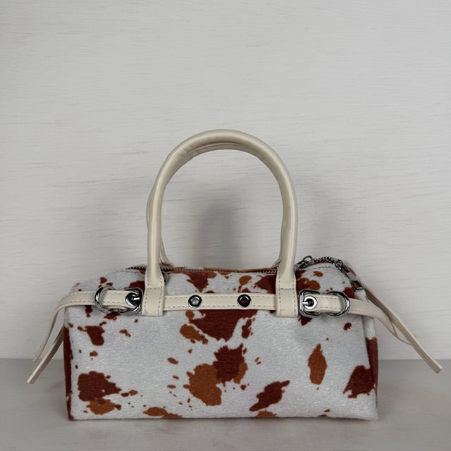 Geweldig handtasje met koeienprint en bandjes