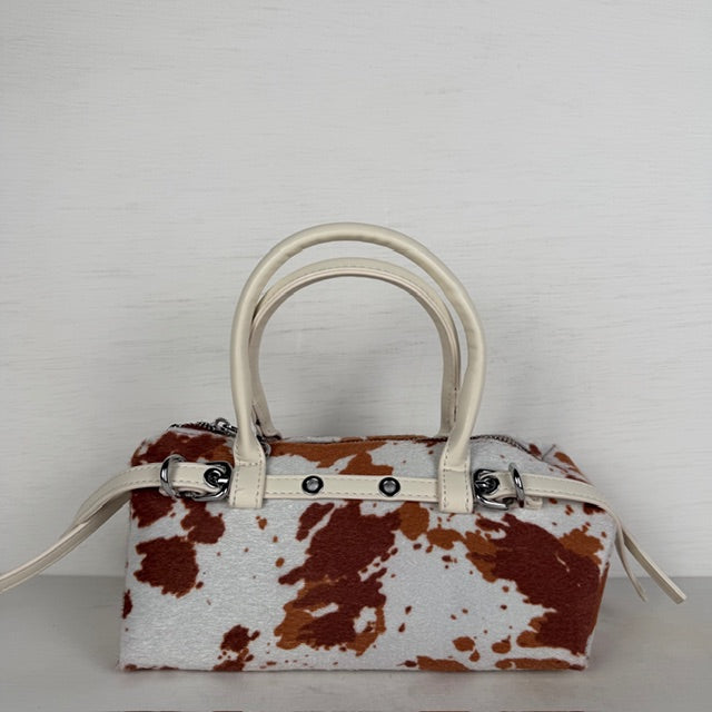 Geweldig handtasje met koeienprint en bandjes