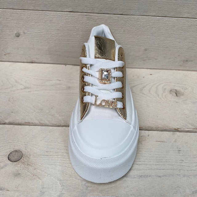 Lage witte sneakers met goud